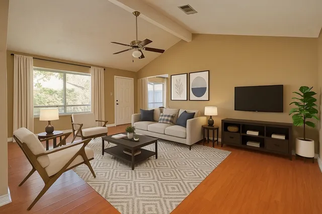 a living room with furniture a flat screen tv and a large window