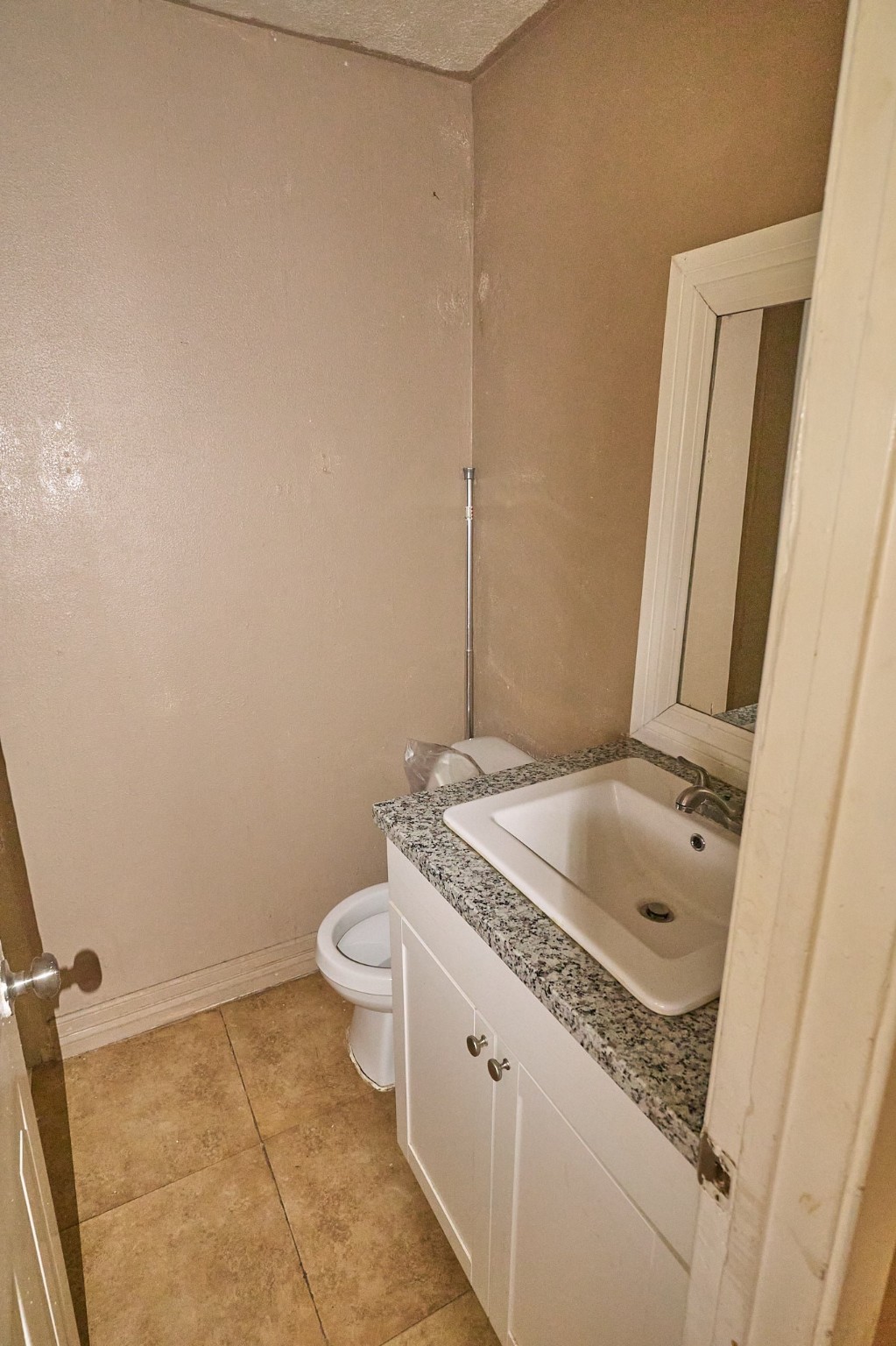 15829 Ridgeroe Lane Houston, TX 77053 - Photo 13 of 16 a bathroom with a granite countertop sink a toilet and a mirror