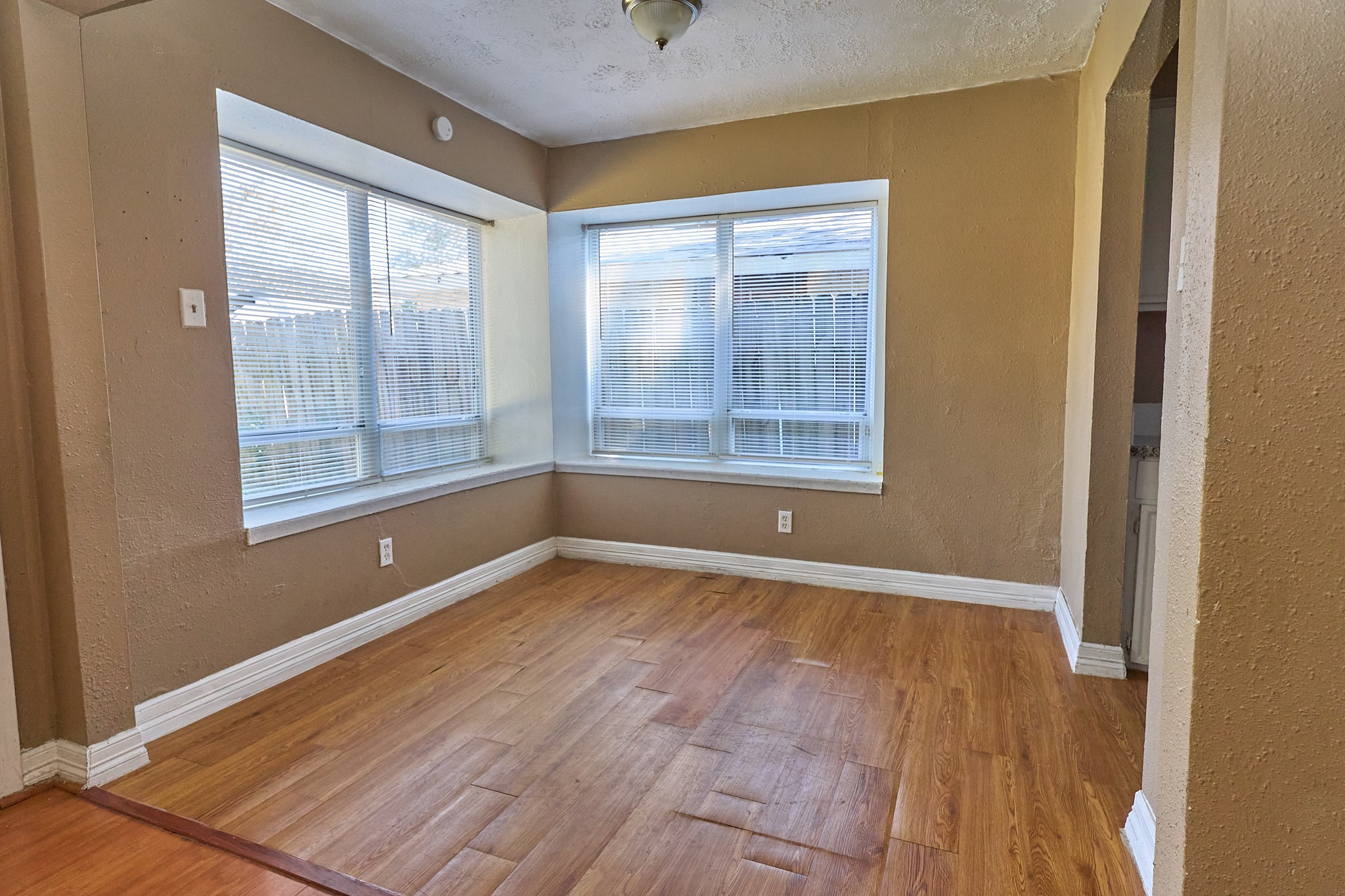 15829 Ridgeroe Lane Houston, TX 77053 - Photo 6 of 16 an empty room with wooden floor and windows