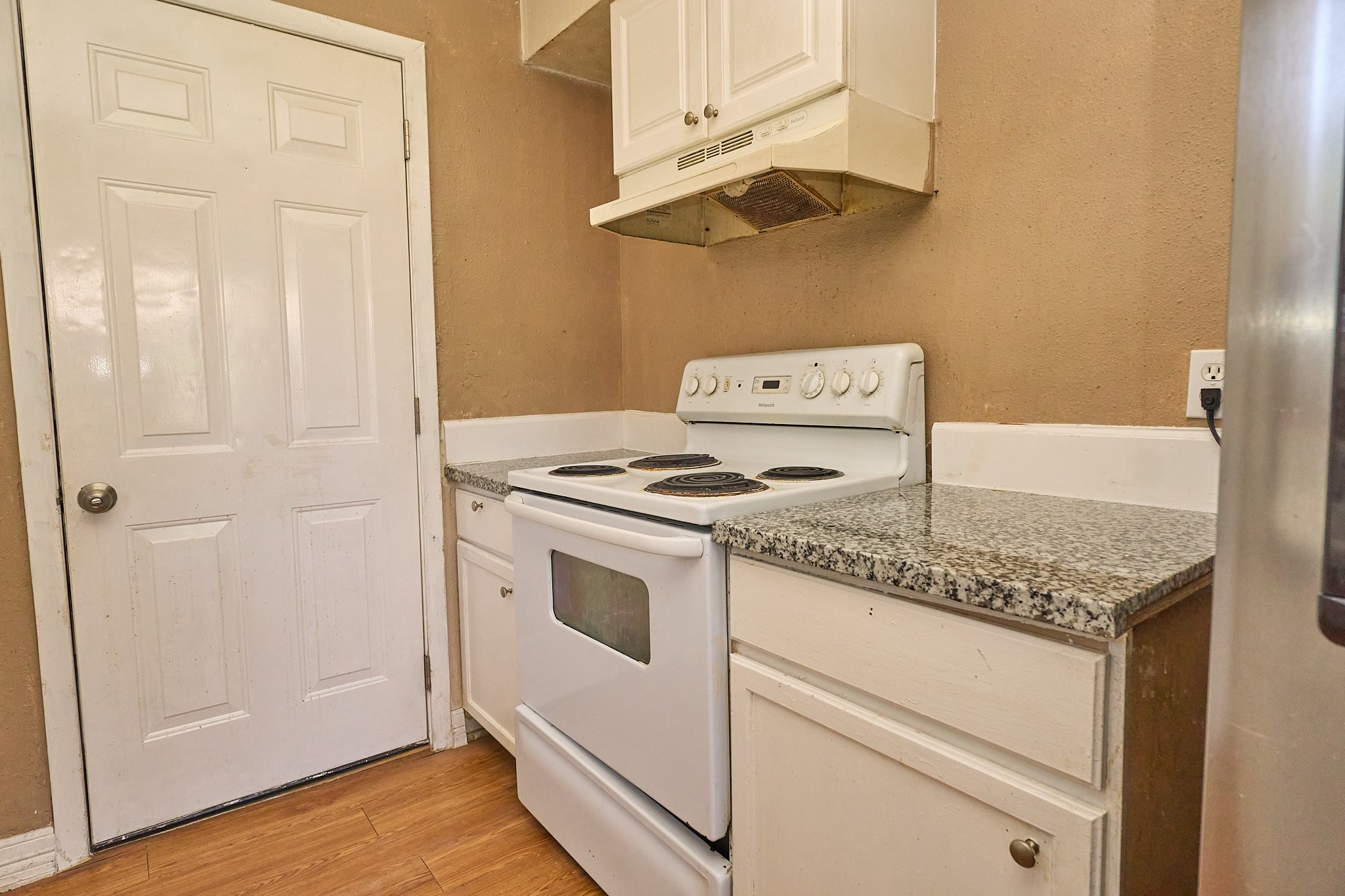 15829 Ridgeroe Lane Houston, TX 77053 - Photo 8 of 16 a kitchen with granite countertop cabinets and white appliances