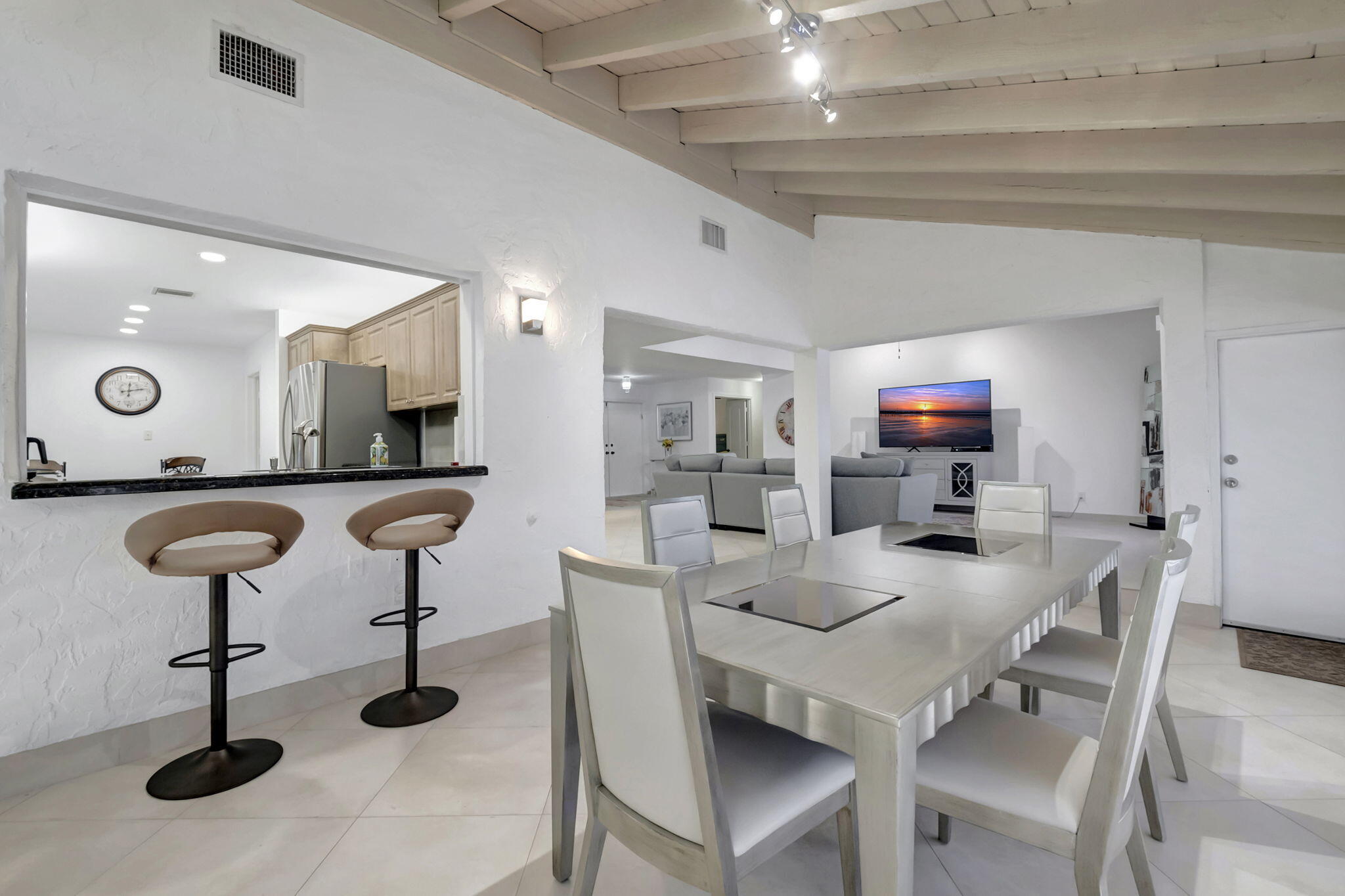 902 Foxpointe Circle Delray Beach, FL 33445 - Photo 15 of 43 a kitchen with a sink a counter space and a view of living room