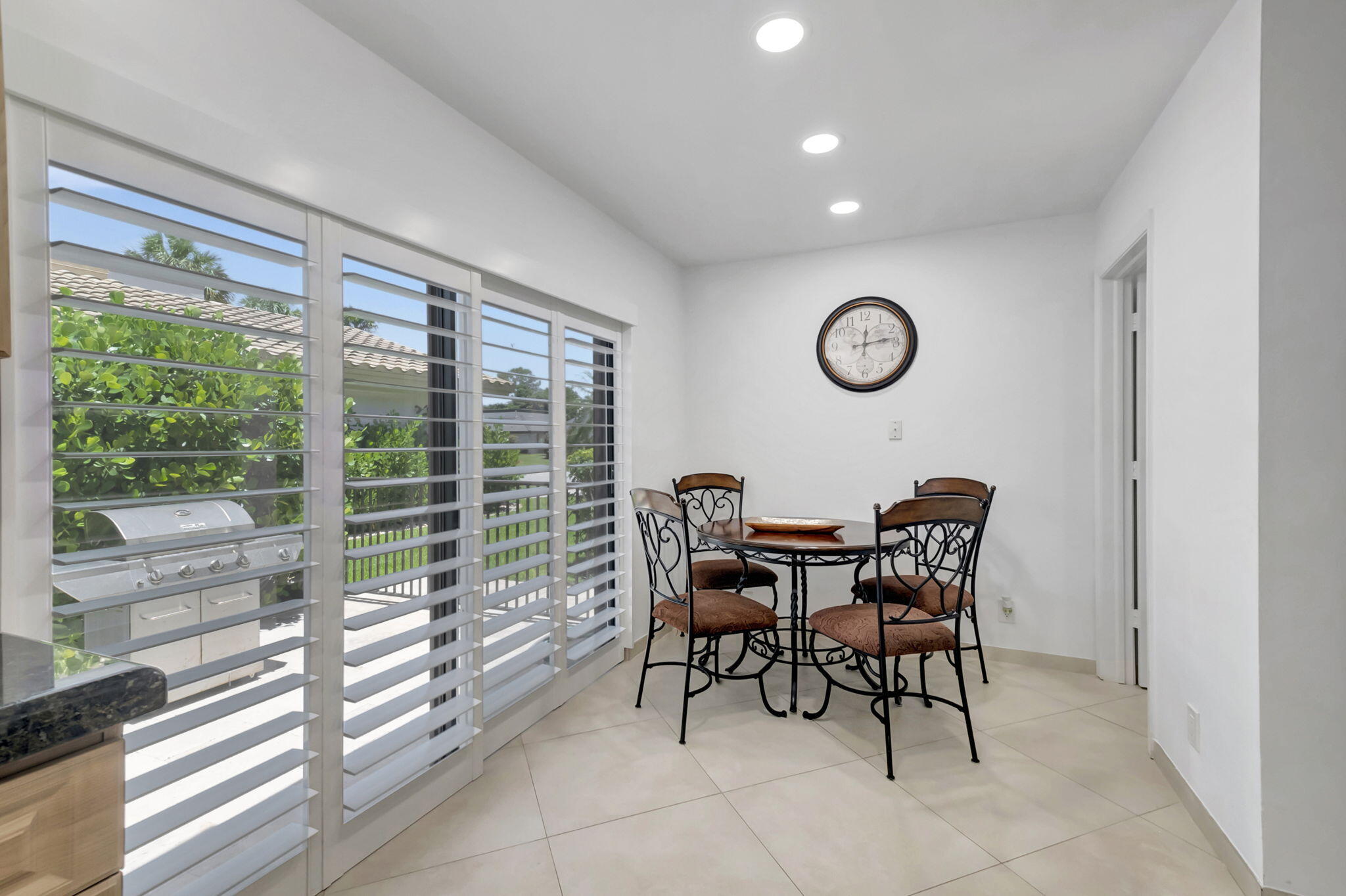 902 Foxpointe Circle Delray Beach, FL 33445 - Photo 16 of 43 a view of a dining room with furniture window and outside view