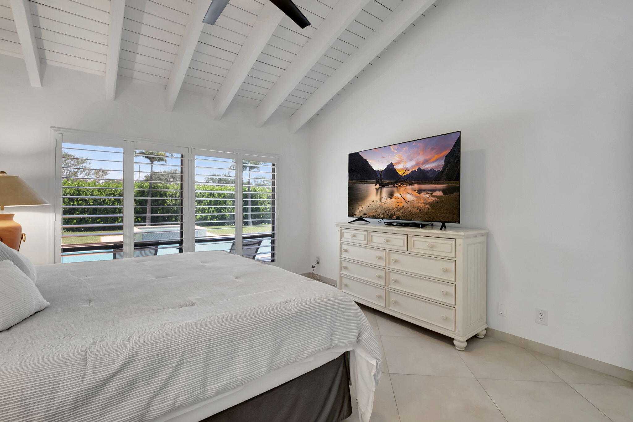 902 Foxpointe Circle Delray Beach, FL 33445 - Photo 27 of 43 a bedroom with furniture and a flat screen tv