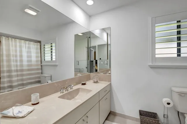 a bathroom with a granite countertop sink mirror and double