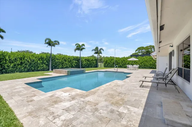 a view of a swimming pool and a yard