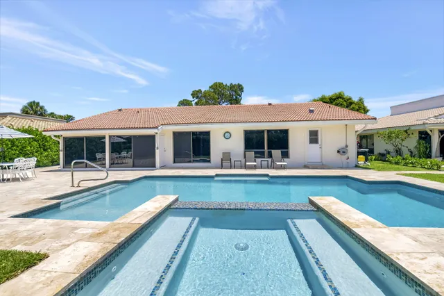 a view of a house with swimming pool and a porch