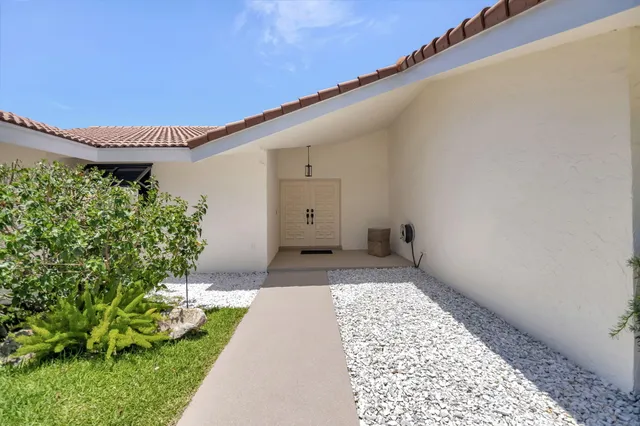 a view of a backyard with potted plants