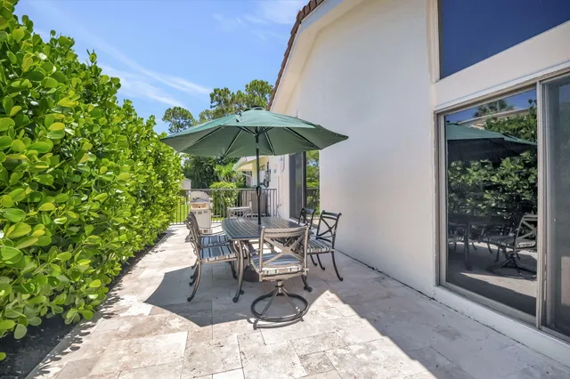 a patio with a patio table and chairs