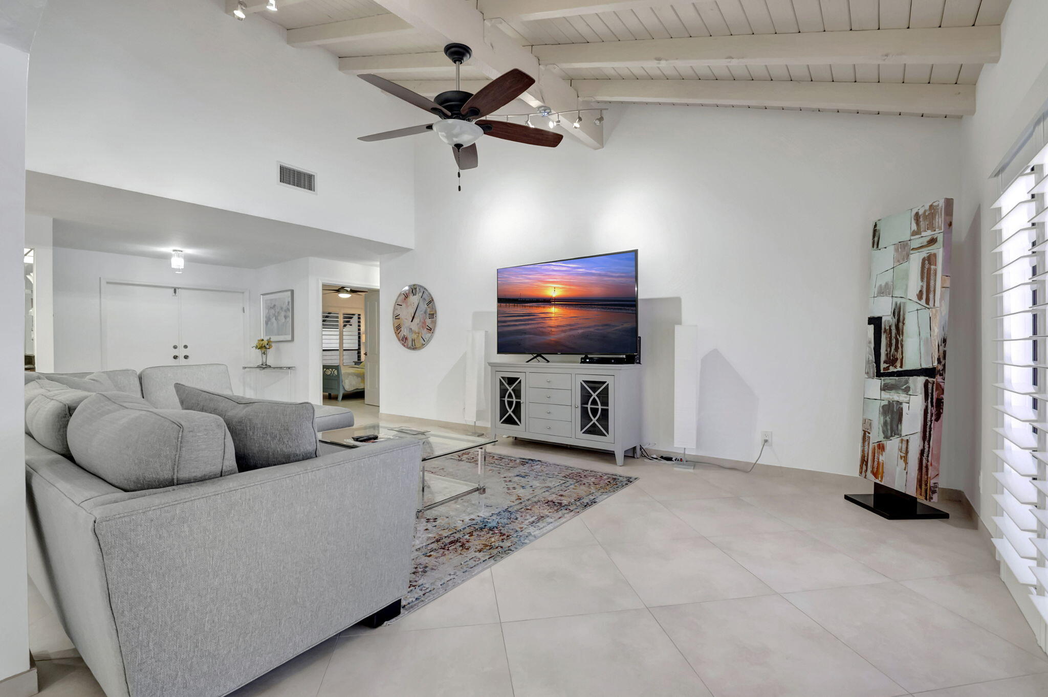 902 Foxpointe Circle Delray Beach, FL 33445 - Photo 10 of 43 a living room with furniture and a flat screen tv
