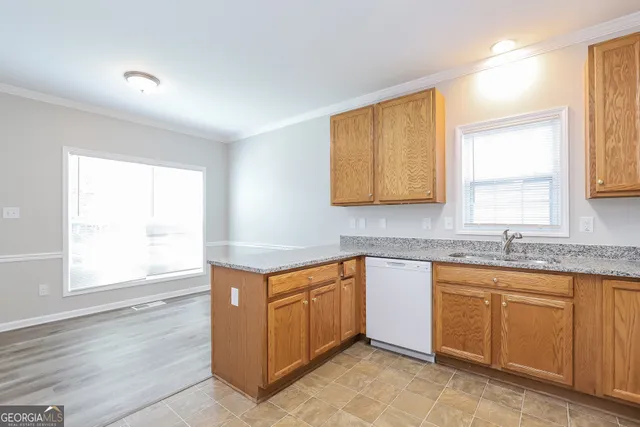 a kitchen with sink cabinets and window