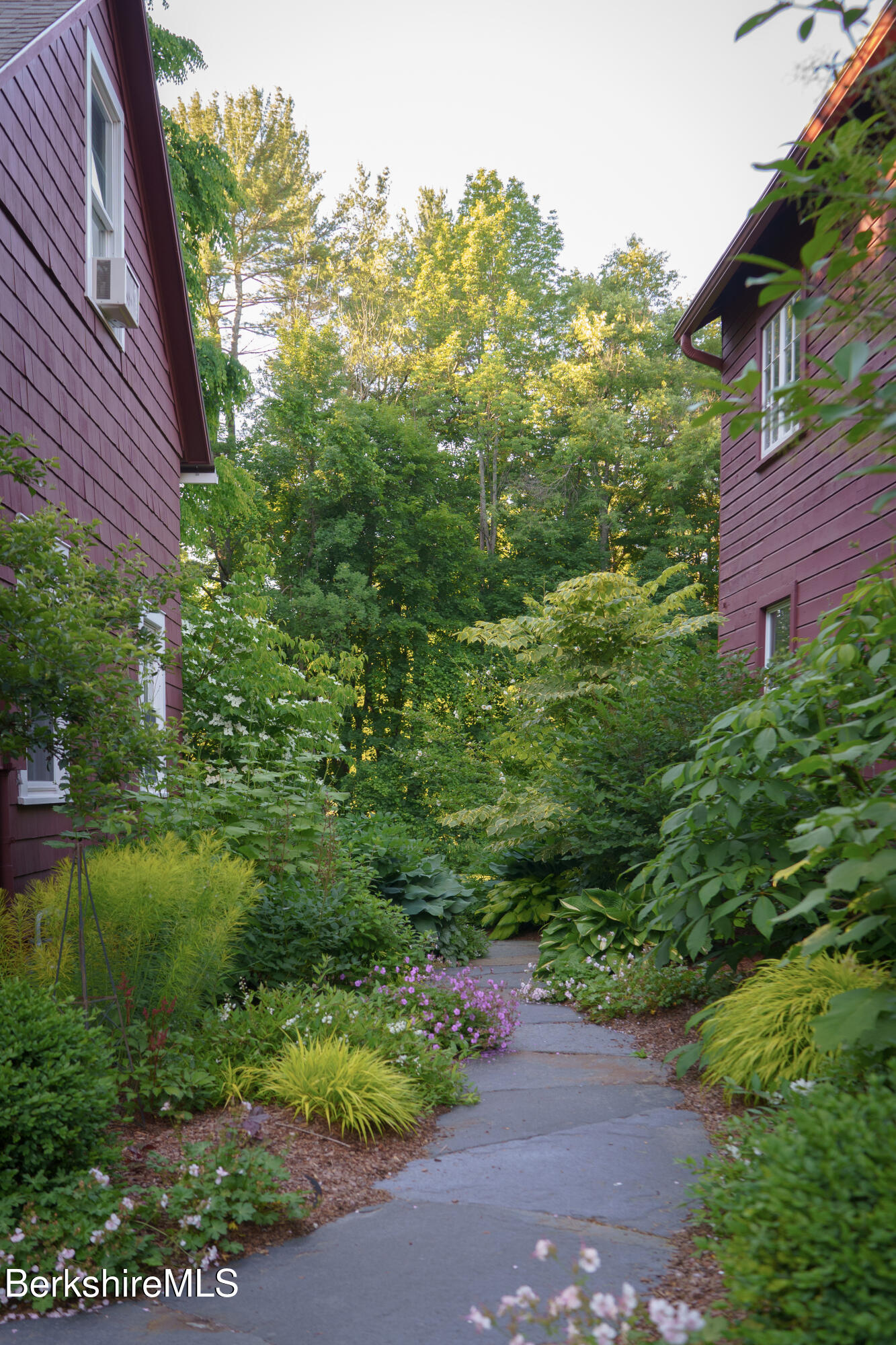 45 Taconic Avenue Lenox, MA 01240 - Photo 21 of 26 a view of a yard with plants and a bench