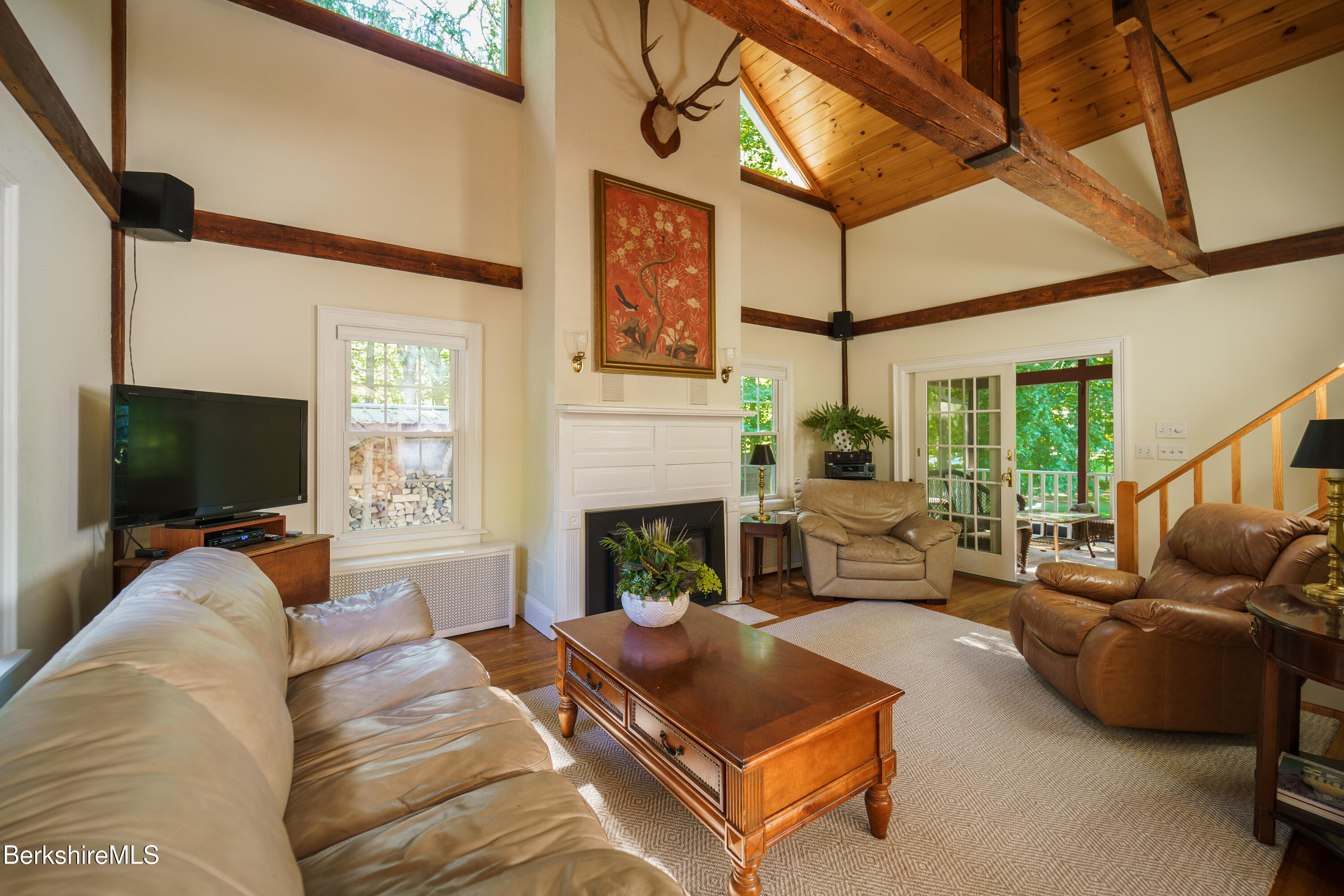 45 Taconic Avenue Lenox, MA 01240 - Photo 3 of 26 a living room with furniture a flat screen tv and a fireplace