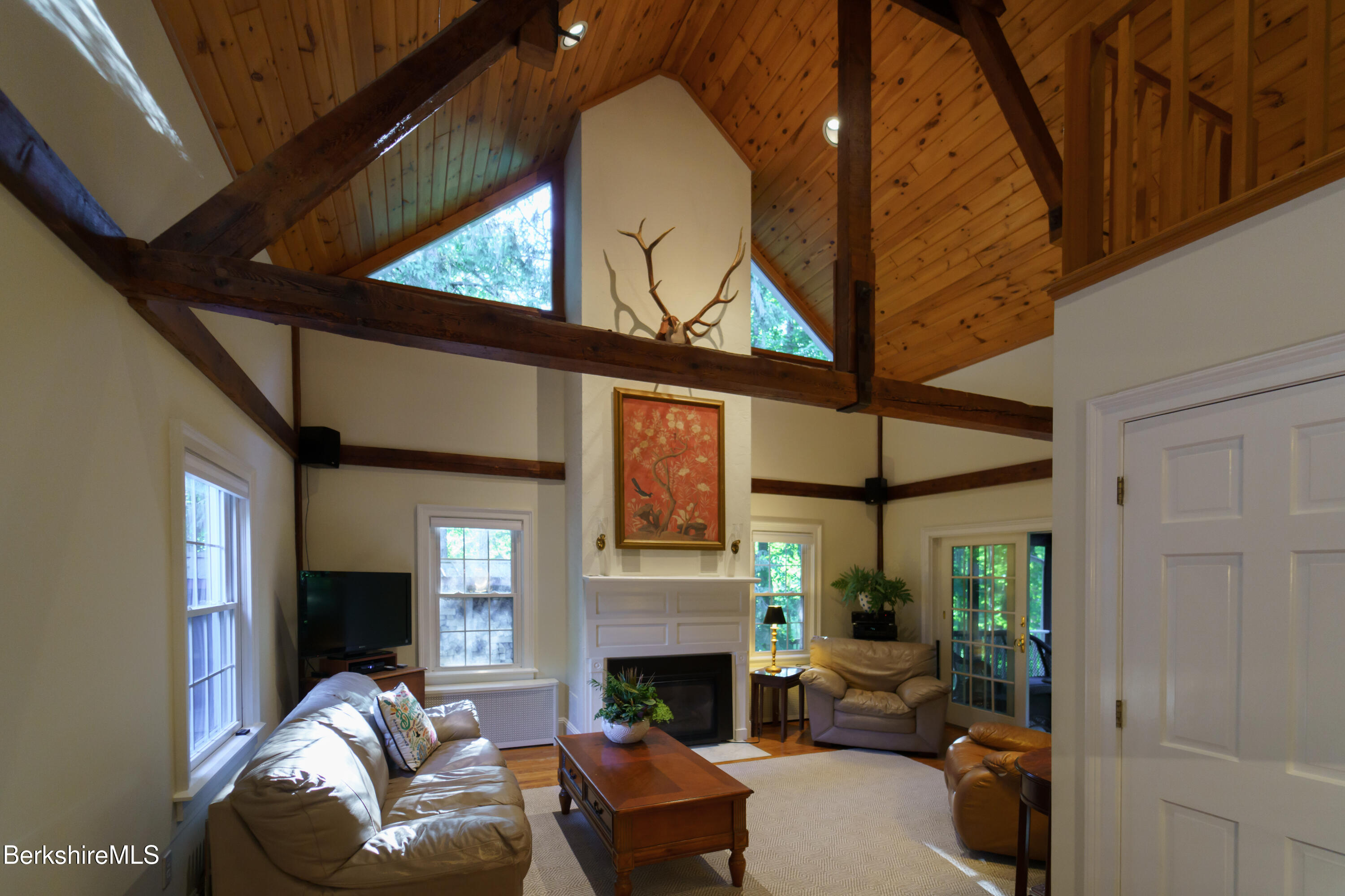 45 Taconic Avenue Lenox, MA 01240 - Photo 5 of 26 a living room with furniture a fireplace and a floor to ceiling window