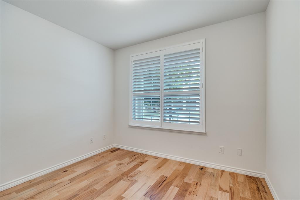 2025 Testament Trail Plano, TX 75074 - Photo 13 of 29 a view of an empty room with wooden floor and a window