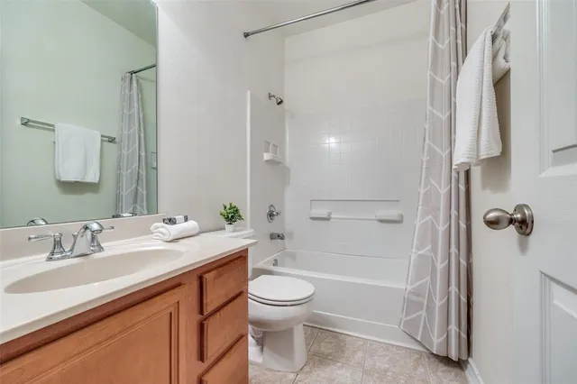 a bathroom with a granite countertop sink a toilet and shower
