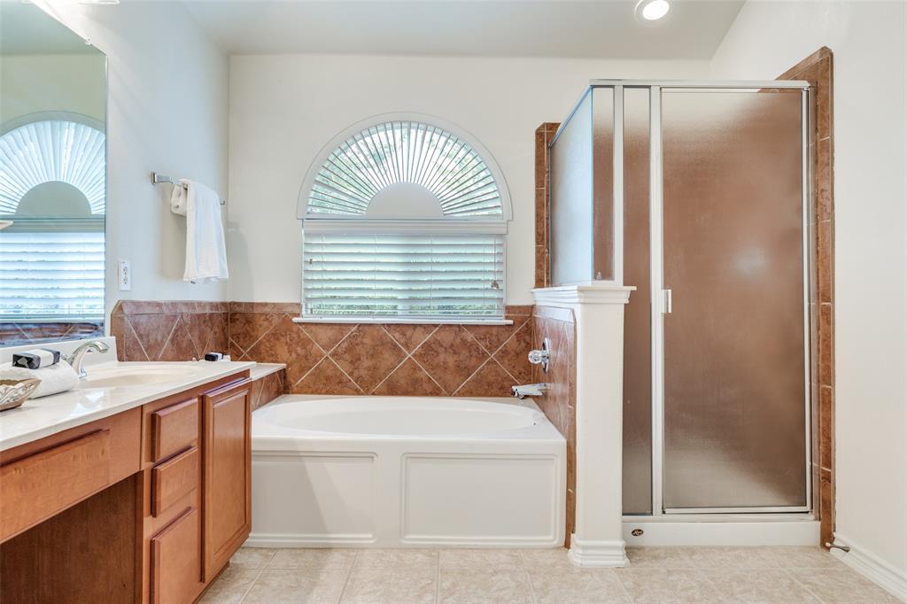 2025 Testament Trail Plano, TX 75074 - Photo 21 of 29 a bathroom with a sink a mirror and a shower