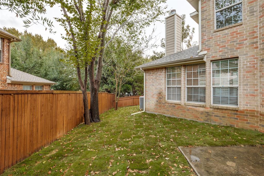2025 Testament Trail Plano, TX 75074 - Photo 25 of 29 a view of a backyard with large trees and wooden fence