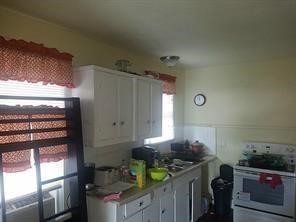 408 Robert Lee Road Houston, TX 77009 - Photo 11 of 13 a kitchen with stainless steel appliances granite countertop a sink stove and cabinets