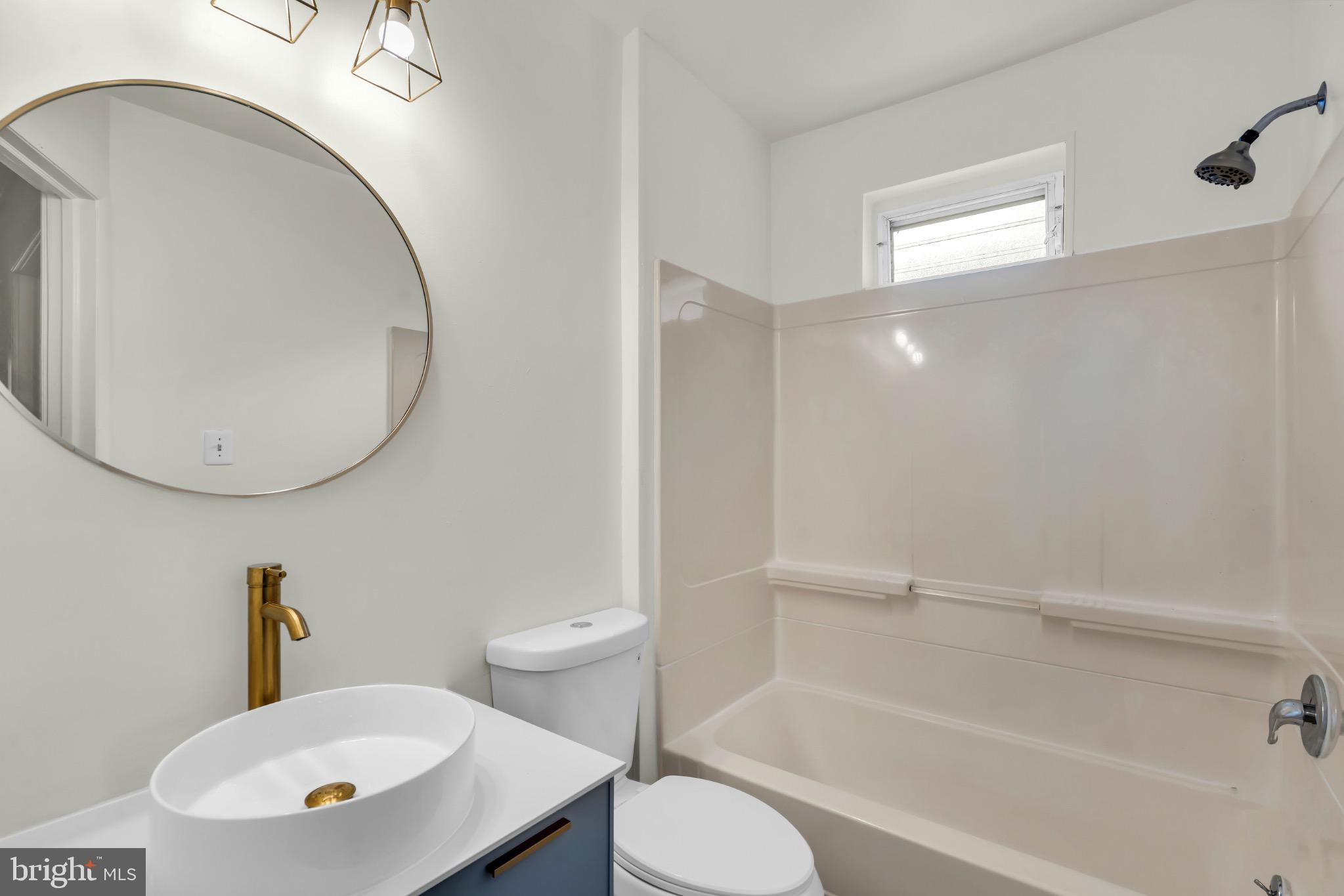 503 Kossuth Street Riverside, NJ 08075 - Photo 13 of 18 a bathroom with a sink a toilet and a mirror