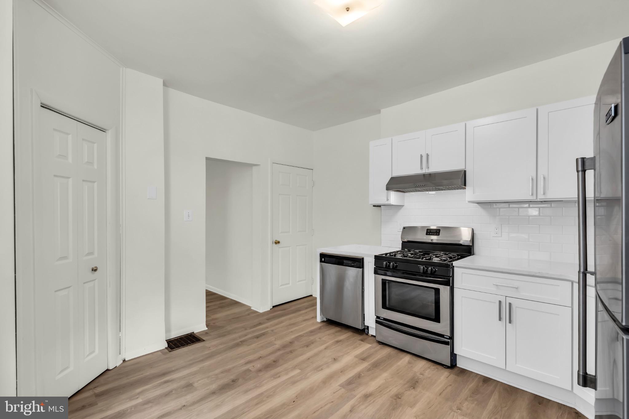 503 Kossuth Street Riverside, NJ 08075 - Photo 7 of 18 a kitchen with granite countertop white cabinets and appliances