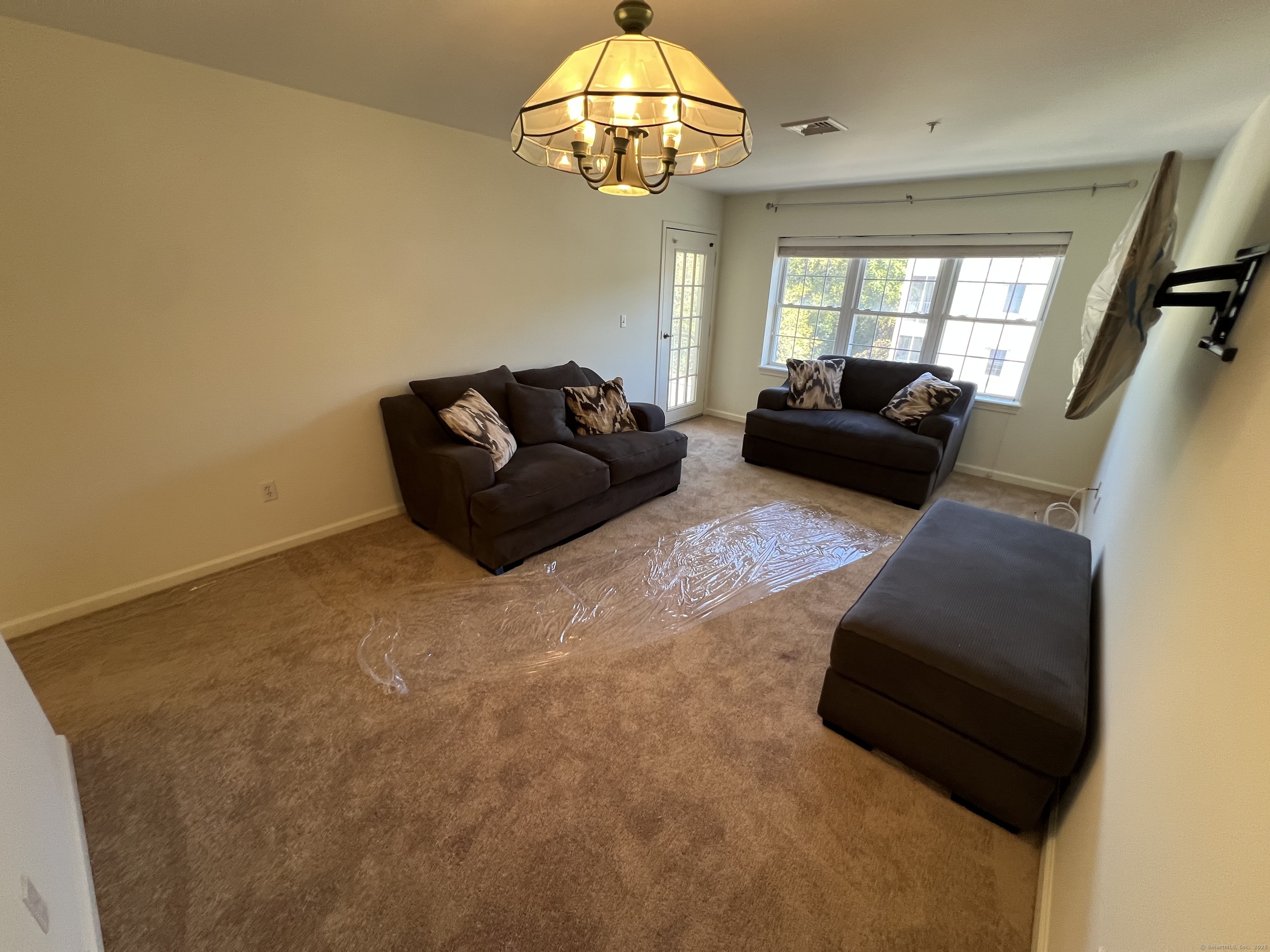 75 Washington Avenue, Unit 8403 Hamden, CT 06518 - Photo 14 of 18 a living room with furniture and a large window