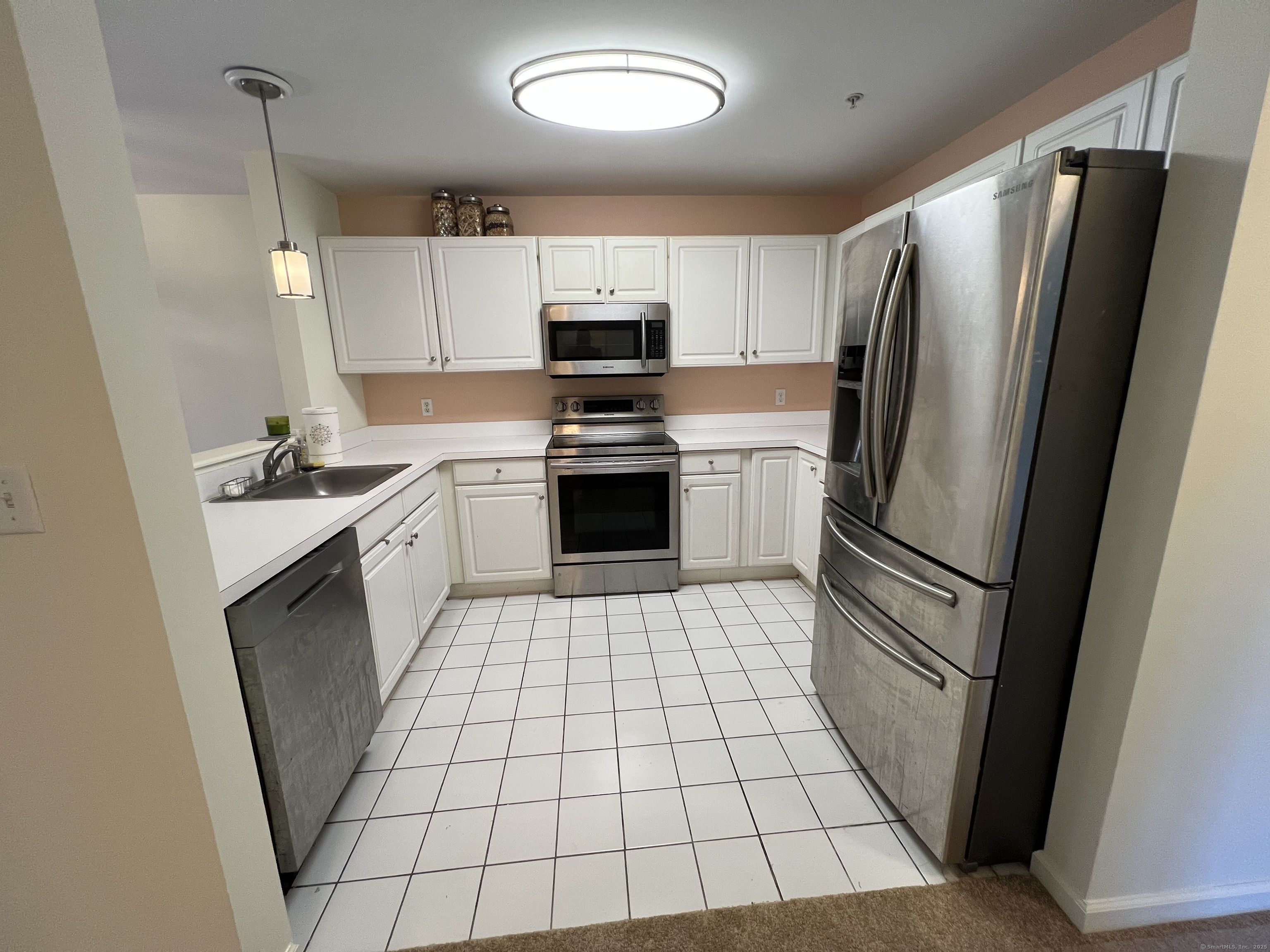 75 Washington Avenue, Unit 8403 Hamden, CT 06518 - Photo 4 of 18 a kitchen with stainless steel appliances a refrigerator sink and microwave