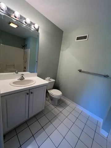 a bathroom with a sink mirror vanity and toilet