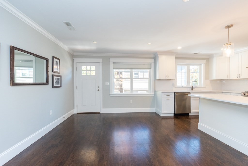 156 Ash Street, Unit 2 Waltham, MA 02453 - Photo 11 of 39 a view of an empty room with window and wooden floor