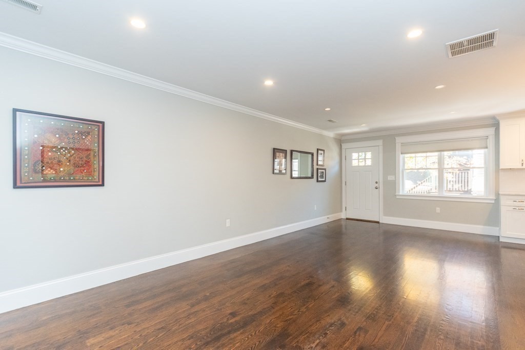 156 Ash Street, Unit 2 Waltham, MA 02453 - Photo 15 of 39 an empty room with wooden floor and windows