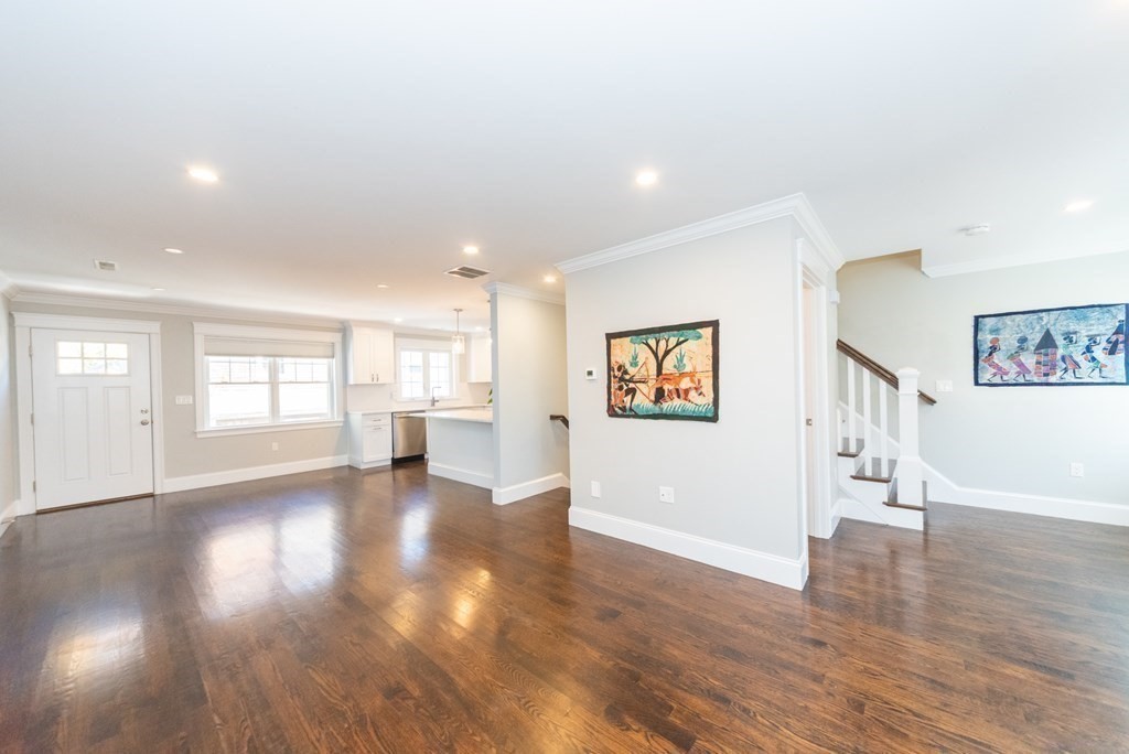 156 Ash Street, Unit 2 Waltham, MA 02453 - Photo 16 of 39 a view of a big room with wooden floors and windows