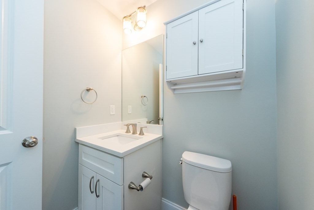 156 Ash Street, Unit 2 Waltham, MA 02453 - Photo 17 of 39 a bathroom with a sink toilet and vanity