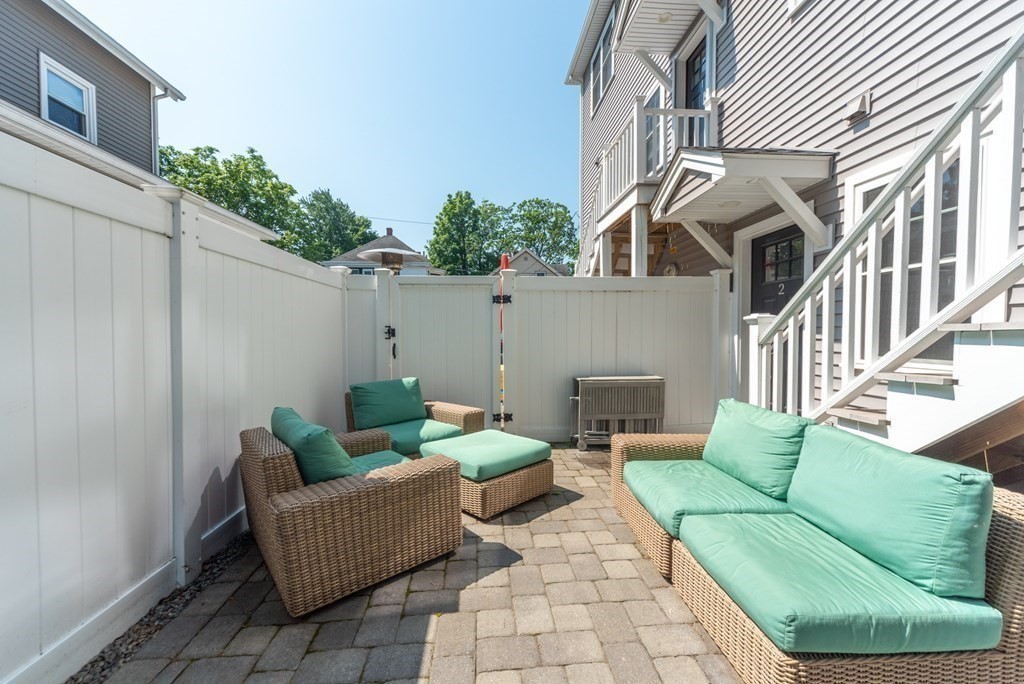 156 Ash Street, Unit 2 Waltham, MA 02453 - Photo 2 of 39 a view of a patio with couches and potted plants