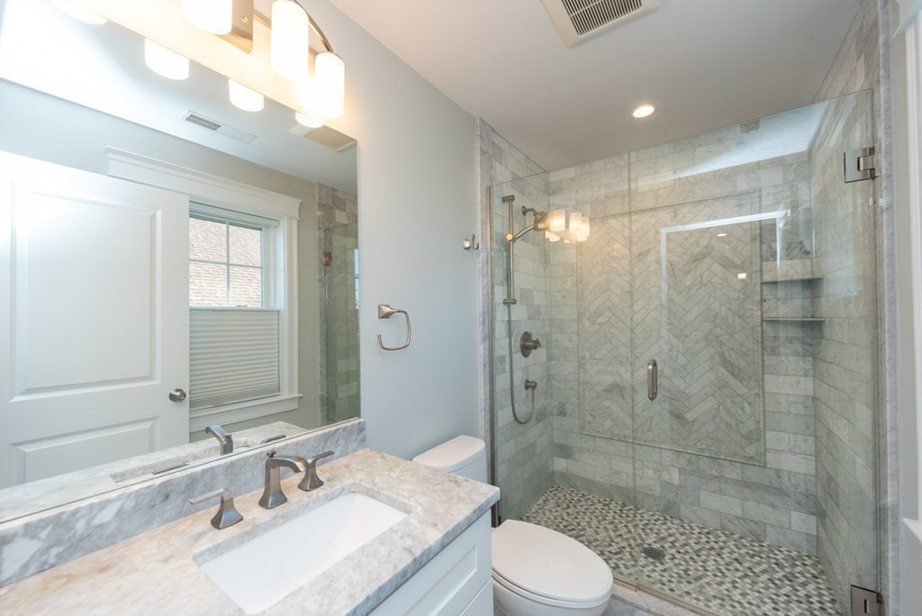 156 Ash Street, Unit 2 Waltham, MA 02453 - Photo 22 of 39 a bathroom with a sink a toilet and shower
