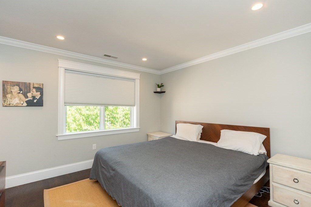 156 Ash Street, Unit 2 Waltham, MA 02453 - Photo 24 of 39 a bedroom with a bed and a window
