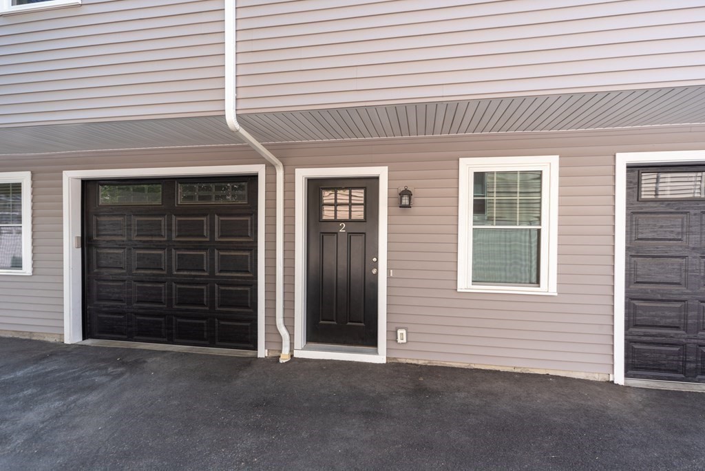 156 Ash Street, Unit 2 Waltham, MA 02453 - Photo 39 of 39 front view of a brick house with a large window