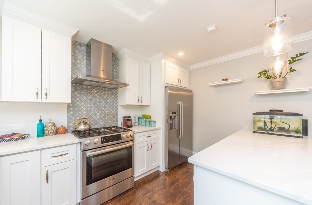 156 Ash Street, Unit 2 Waltham, MA 02453 - Photo 4 of 39 a kitchen with a refrigerator sink and stove