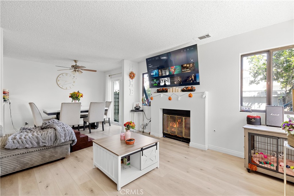 8784 Hewitt Place, Unit 12 Garden Grove, CA 92844 - Photo 17 of 54 a living room with furniture a fireplace and a window