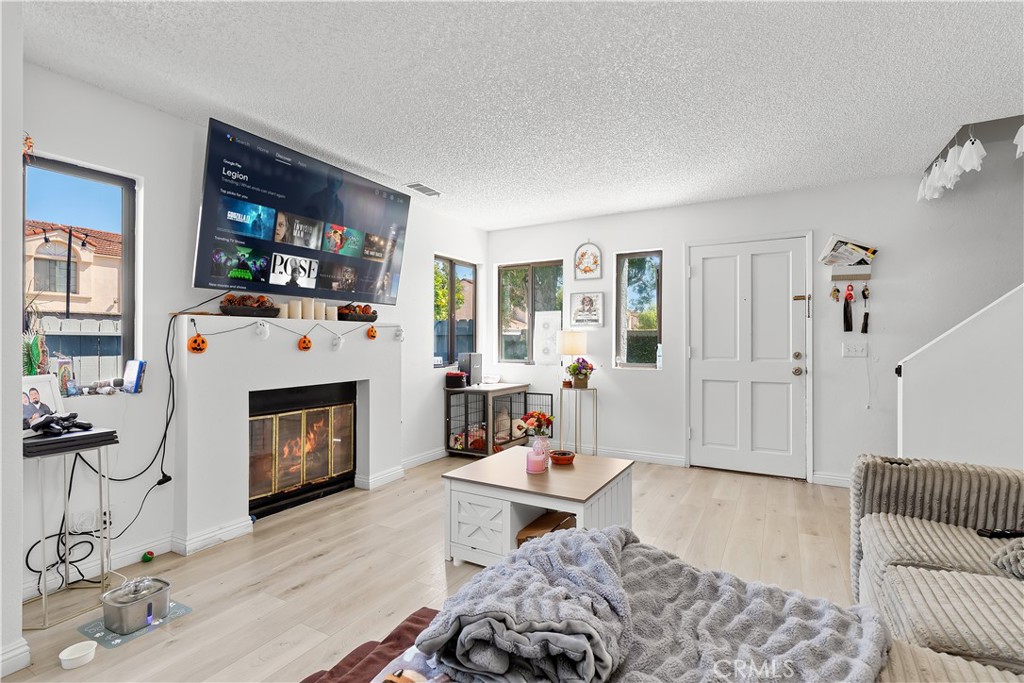 8784 Hewitt Place, Unit 12 Garden Grove, CA 92844 - Photo 18 of 54 a living room with furniture and a fireplace