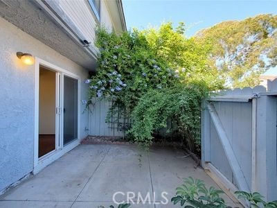 8784 Hewitt Place, Unit 12 Garden Grove, CA 92844 - Photo 2 of 54 a view of backyard with potted plants and wooden fence