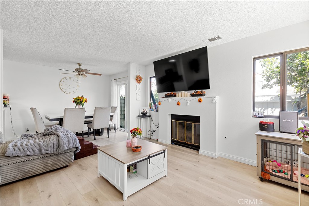8784 Hewitt Place, Unit 12 Garden Grove, CA 92844 - Photo 24 of 54 a living room with furniture a fireplace and a flat screen tv