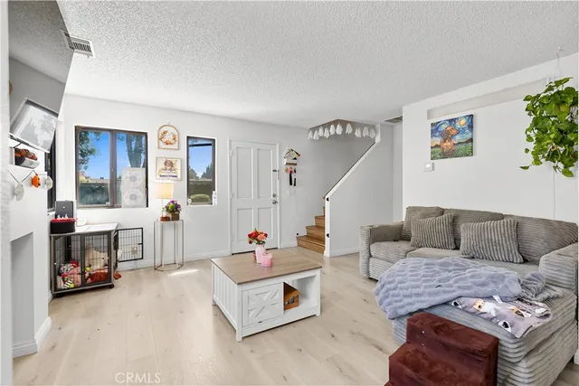 a kitchen with stainless steel appliances a sink a stove a chimney a refrigerator and cabinets