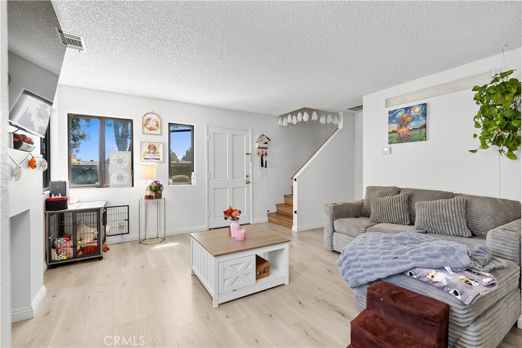 8784 Hewitt Place, Unit 12 Garden Grove, CA 92844 - Photo 26 of 54 a living room with furniture and a wooden floor