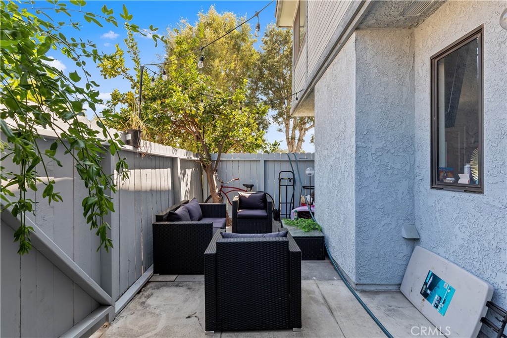 8784 Hewitt Place, Unit 12 Garden Grove, CA 92844 - Photo 32 of 54 a view of a patio with couches and table and chairs and potted plants