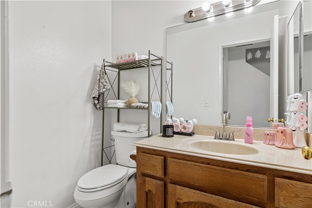 8784 Hewitt Place, Unit 12 Garden Grove, CA 92844 - Photo 34 of 54 a bathroom with a sink toilet and mirror