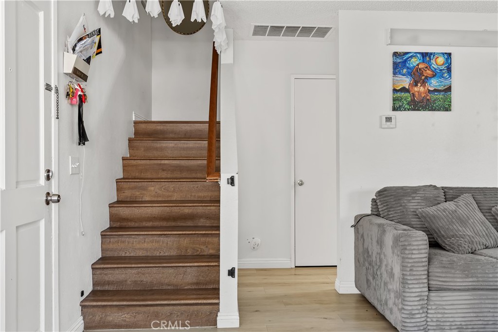 8784 Hewitt Place, Unit 12 Garden Grove, CA 92844 - Photo 36 of 54 a living room with furniture and a stairs