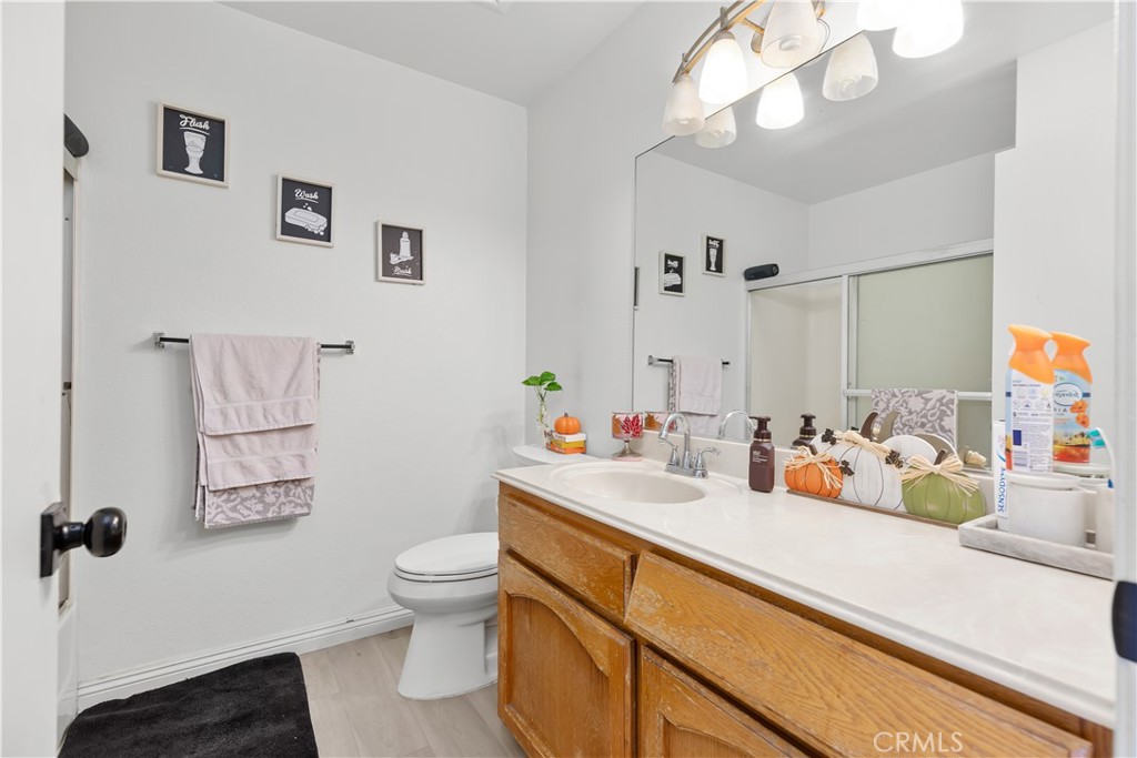 8784 Hewitt Place, Unit 12 Garden Grove, CA 92844 - Photo 37 of 54 a bathroom with a sink a toilet and a mirror