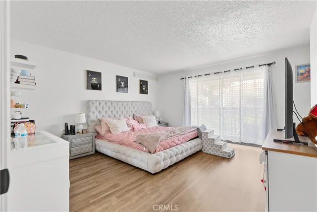 a view of a kitchen area with furniture and wooden floor