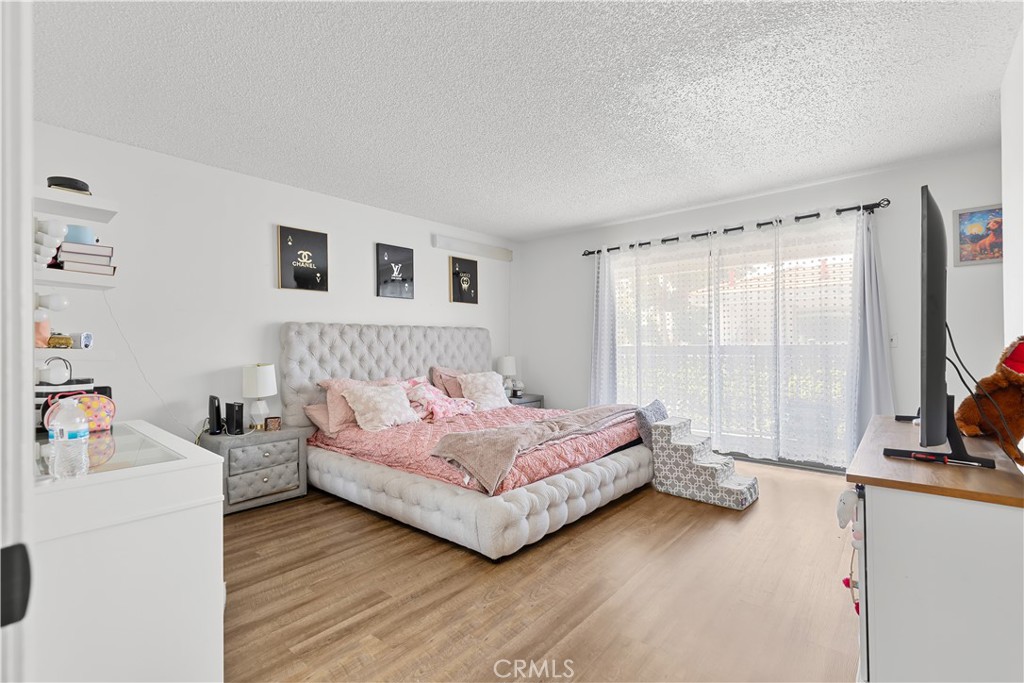 8784 Hewitt Place, Unit 12 Garden Grove, CA 92844 - Photo 38 of 54 a bedroom with a bed and a large window