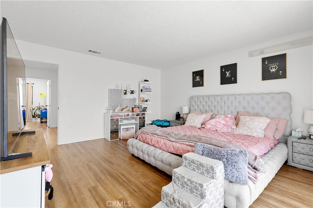 8784 Hewitt Place, Unit 12 Garden Grove, CA 92844 - Photo 39 of 54 a bedroom with a bed and a view of kitchen