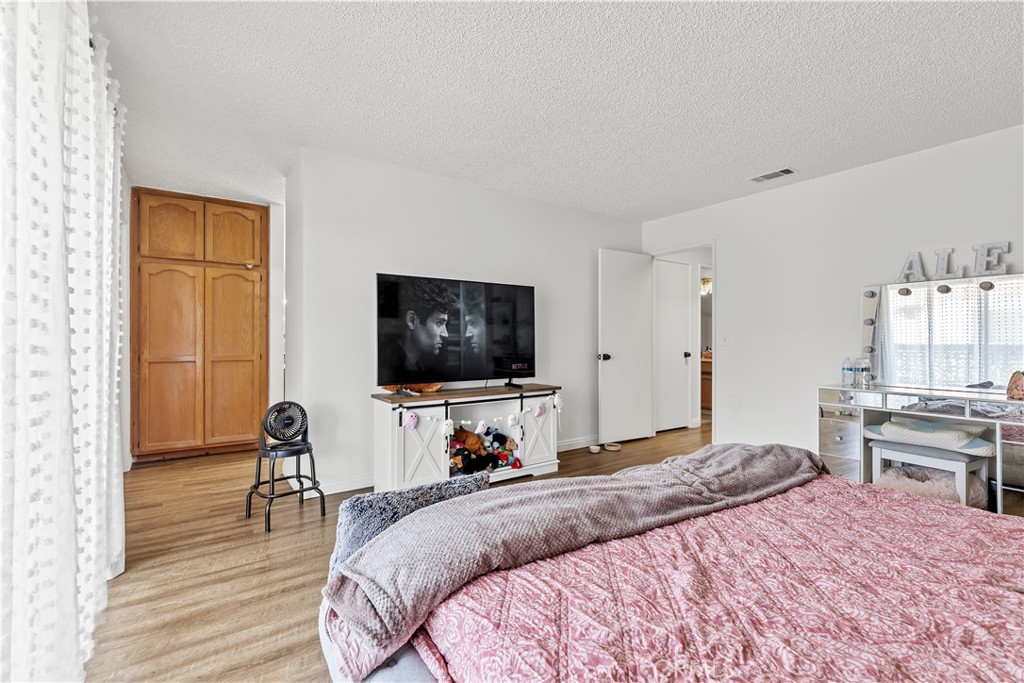 8784 Hewitt Place, Unit 12 Garden Grove, CA 92844 - Photo 40 of 54 a bedroom with a bed and a flat screen tv